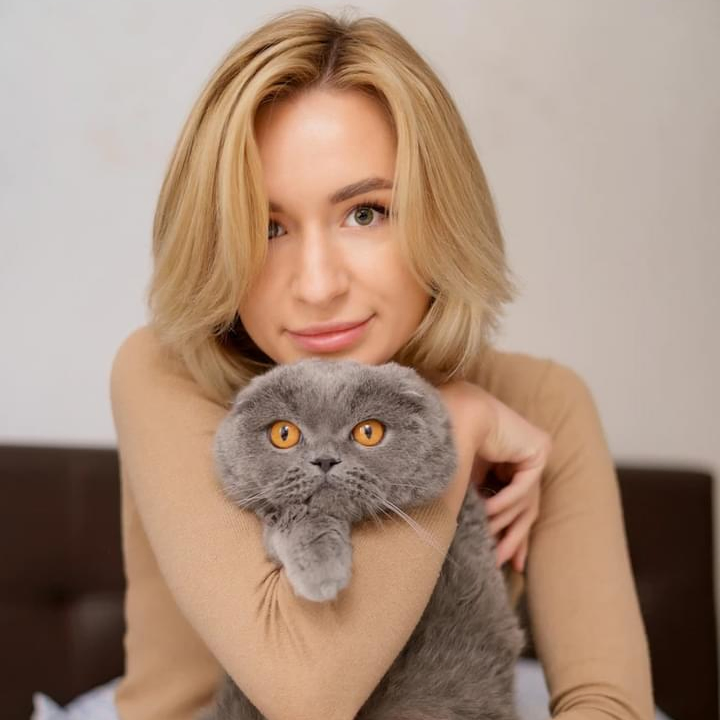 Cat owner hugging her Domestic Shorthair cat